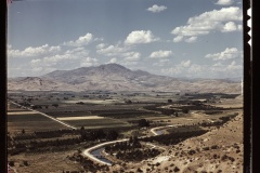 Emmett Valley 1941. Orchards and irrigation ditch. Squaw Butte in the distance.